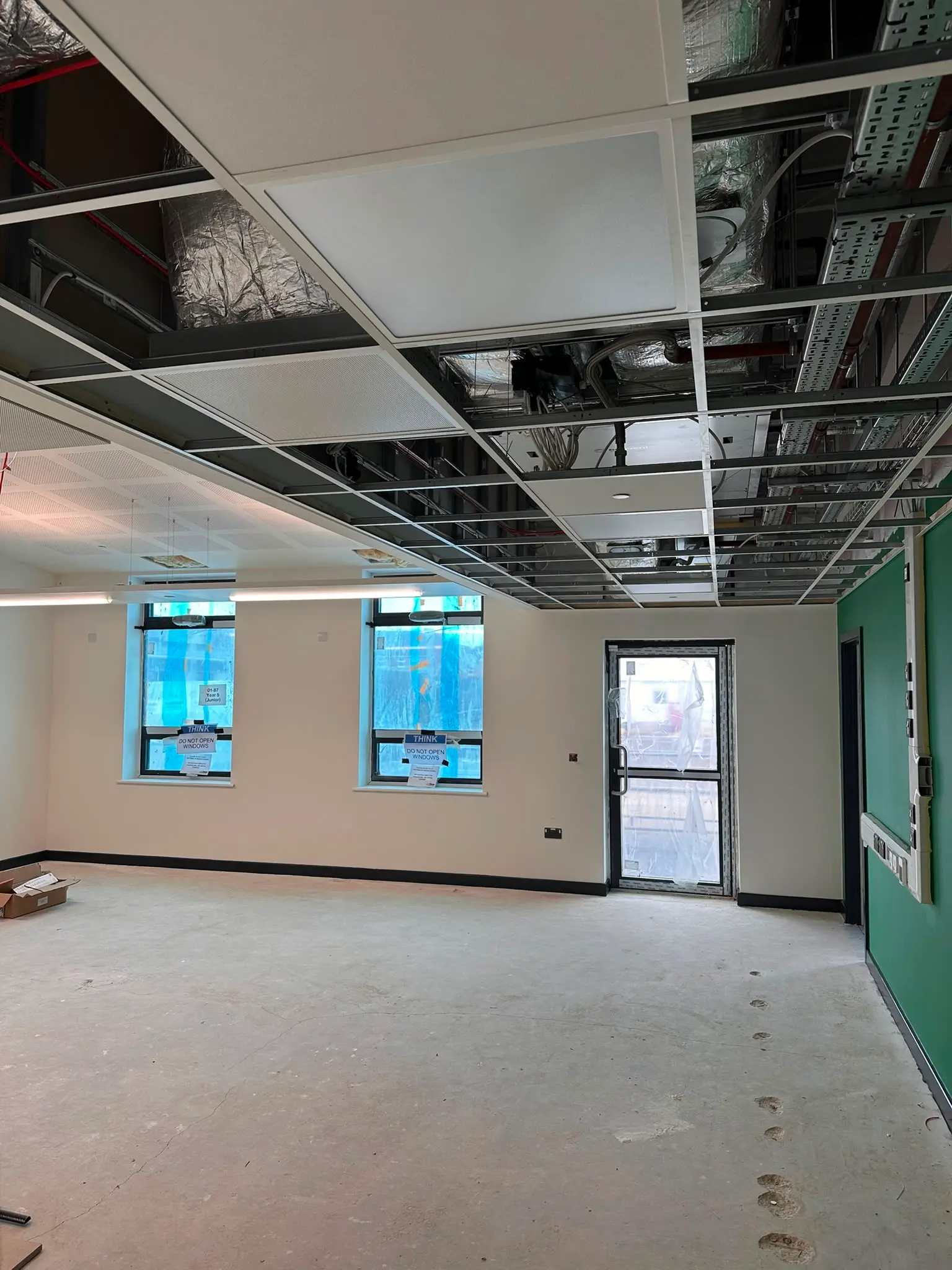 Large commercial suspended ceiling project with acoustic ceiling tiles and integrated services