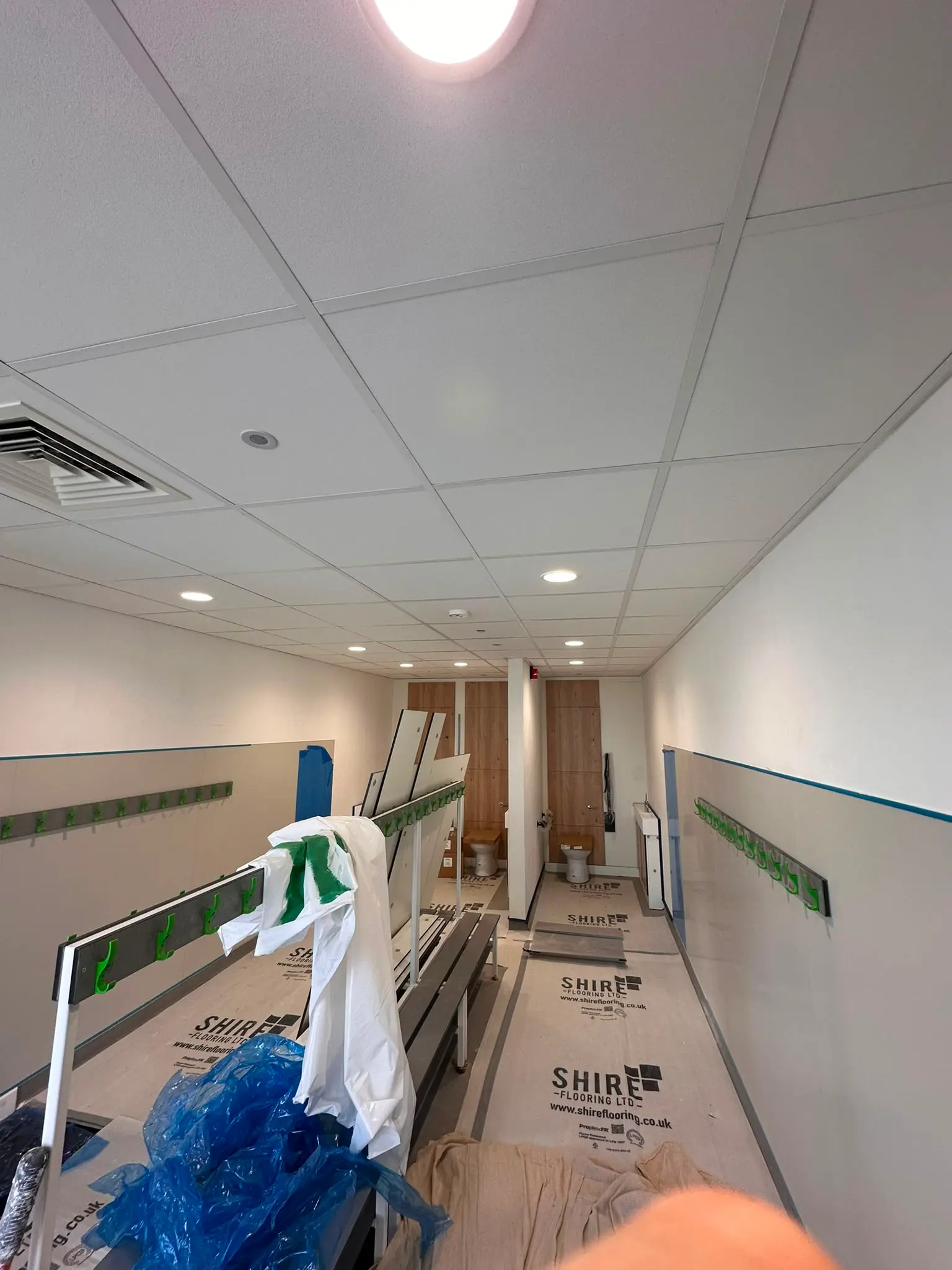 Large commercial suspended ceiling project with acoustic ceiling tiles and integrated services completed
