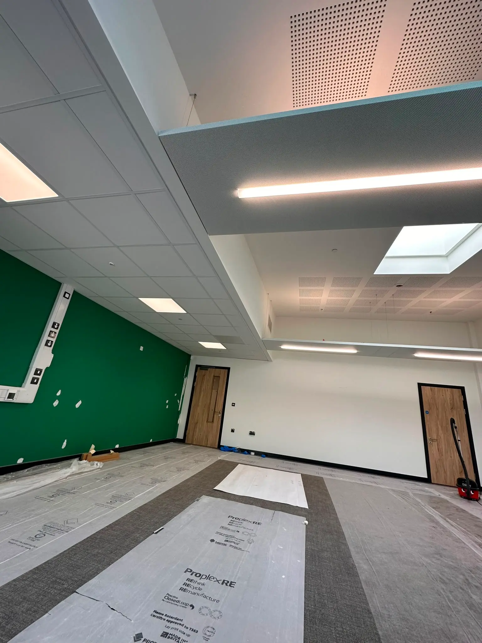 Large commercial suspended ceiling project with acoustic ceiling tiles and integrated services completed 2